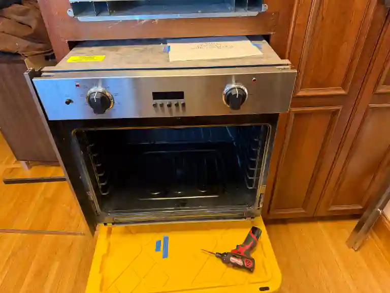 Wall oven mid-repair by appliance technician in Minneapolis