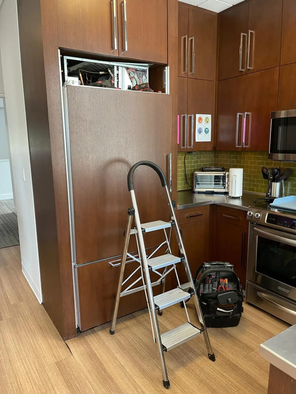 Refrigerator repair in progress by certified technician
